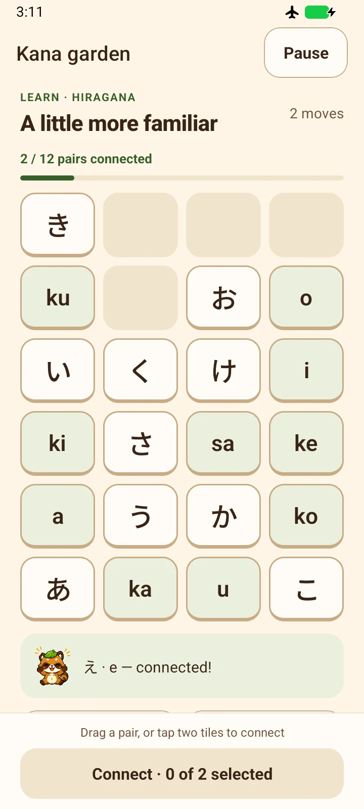 Tanuki Tango on Android: a hiragana board with Japanese characters and their sounds, two of twelve pairs connected, and Tanji celebrating a match.